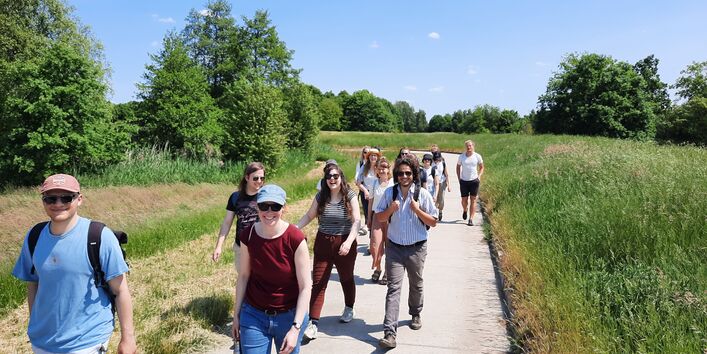 Exkursionsteilnehmende im Wendland gehen zusammen auf einem Feldweg.